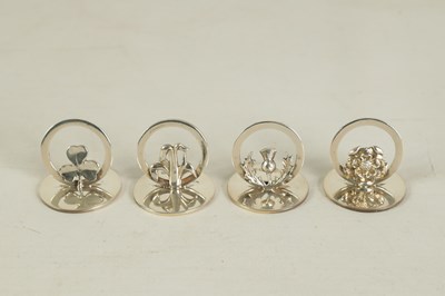 Lot 322 - A CASED SET OF FOUR SILVER SYMBOLIC MENU HOLDERS