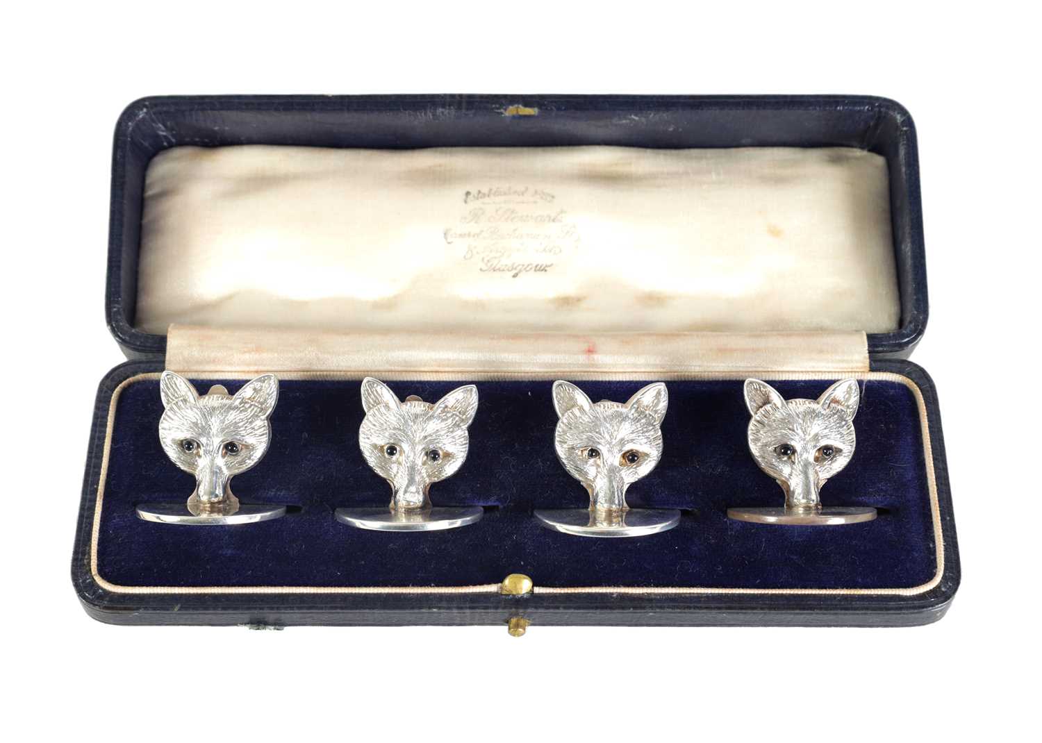 Lot 346 - A CASED SET OF FOUR FOX HEAD SILVER MENU HOLDERS