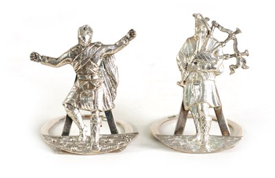 Lot 342 - A PAIR OF SCOTTISH BAGPIPER AND DANCE SILVER MENU HOLDERS