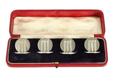 Lot 466 - A CASED SET OF FOUR SILVER CRICKET MENU HOLDERS