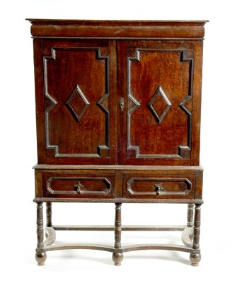 Lot 1414 - AN EARLY 18TH CENTURY OAK GEOMETRIC MOULDED CABINET ON STAND