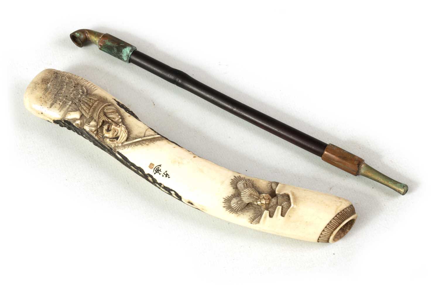 Lot 231 - A MEIJI PERIOD JAPANESE CARVED ANTLER PIPE