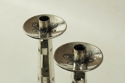 Lot 431 - A PAIR OF ARTS AND CRAFTS PLEMISHED SILVERED COPPER STYLISED CANDLESTICKS