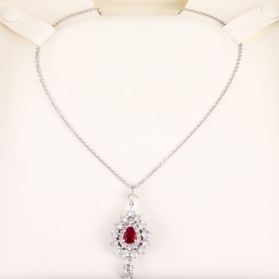 Lot 157 - AN 18ct WHITE GOLD RUBY AND DIAMOND PENDANT of...