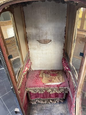 Lot 103 - AN EARLY/MID18TH CENTURY CARVED GILT-WOOD AND STUDDED LEATHER SEDAN CHAIR