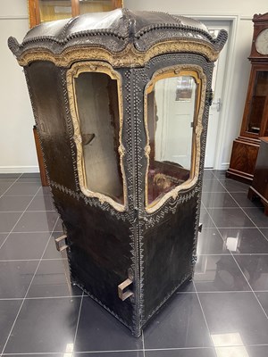 Lot 103 - AN EARLY/MID18TH CENTURY CARVED GILT-WOOD AND STUDDED LEATHER SEDAN CHAIR