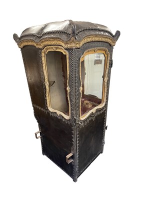 Lot 103 - AN EARLY/MID18TH CENTURY CARVED GILT-WOOD AND STUDDED LEATHER SEDAN CHAIR