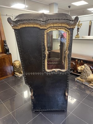 Lot 103 - AN EARLY/MID18TH CENTURY CARVED GILT-WOOD AND STUDDED LEATHER SEDAN CHAIR