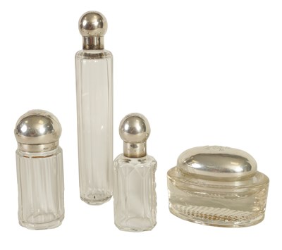 Lot 355 - THREE VICTORIAN SILVER-TOPPED GLASS DRESSING CASE BOTTLES AND A LIDDED DISH