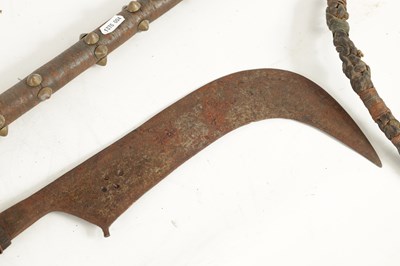 Lot 384 - A 19TH CENTURY AFRICAN SCYTHE AND WHIP