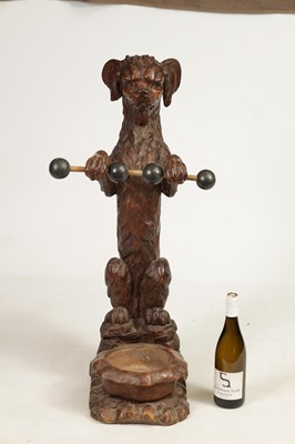 Lot 1130 - A 19TH-CENTURY BLACK FOREST CARVED WALNUT STICK STAND FORMED AS A BEGGING DOG