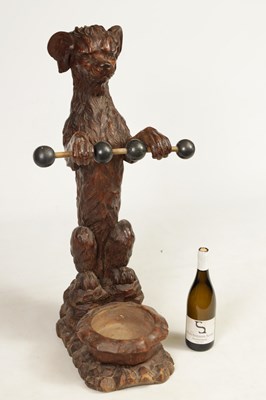 Lot 1130 - A 19TH-CENTURY BLACK FOREST CARVED WALNUT STICK STAND FORMED AS A BEGGING DOG