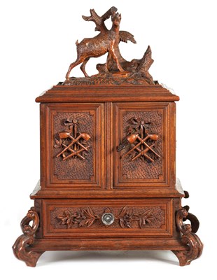 Lot 892 - A 19TH CENTURY CARVED WALNUT BLACK FOREST CIGAR CABINET