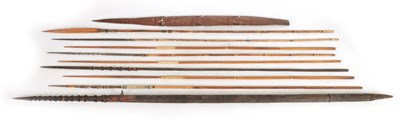 Lot 128 - A 19TH CENTURY TRIBAL CLUB/STAFF WITH A COLLECTION OF TRIBAL FISHING SPEARS