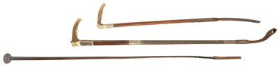 Lot 486 - A COLLECTION OF THREE WOOD AND LEATHER-BOUND RIDING CROPS