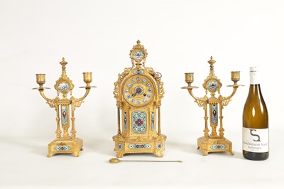 Lot 791 - A LATE 19TH CENTURY FRENCH GILT METAL AND CHAMPLEVE ENAMEL CLOCK GARNITURE