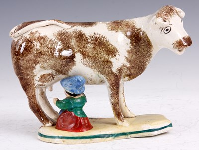 Lot 291 - A MID 19th CENTURY COW AND MILK MAID CREAMER...
