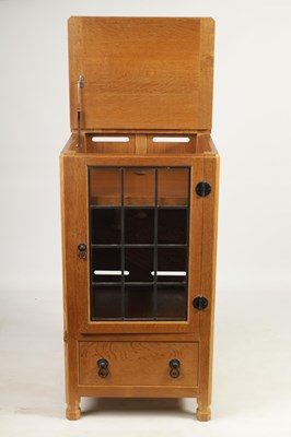 Lot 847 - AN UNUSUAL ROBERT ‘MOUSEMAN’ THOMPSON JOINED ADZED LIGHT OAK  MUSIC CABINET/CENTRE