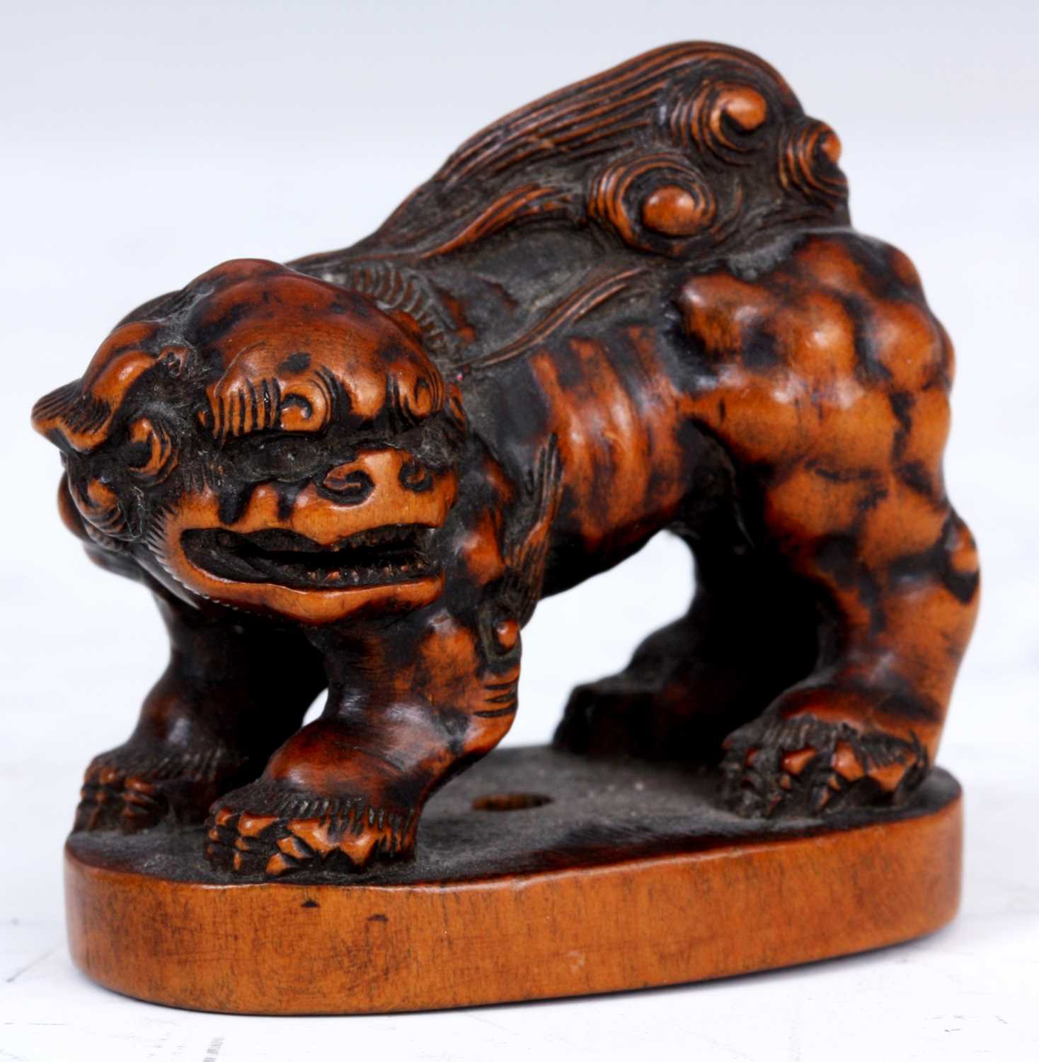 Lot 101 - A JAPANESE BOXWOOD NETSUKE of a Foo Dog stood...