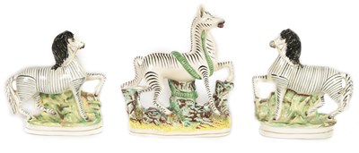 Lot 74 - A PAIR OF 19TH CENTURY STAFFORDSHIRE ZEBRAS AND A SIMILAR LARGER EXAMPLE