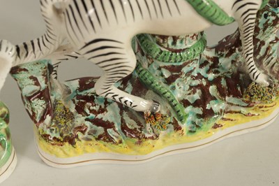 Lot 74 - A PAIR OF 19TH CENTURY STAFFORDSHIRE ZEBRAS AND A SIMILAR LARGER EXAMPLE