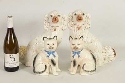 Lot 45 - A LARGE PAIR OF VICTORIAN SEATED STAFFORDSHIRE DOGS together with A PAIR OF SEATED MODELS OF CATS