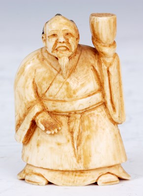 Lot 108 - A JAPANESE IVORY NETSUKE of an oriental man in...