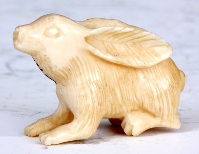 Lot 110 - A JAPANESE IVORY NETSUKE of a hare, signature...