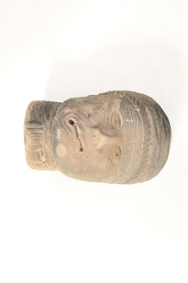 Lot 517 - AN EARLY EASTERN CARVED RED SANDSTONE HEAD