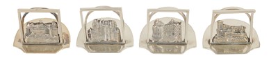 Lot 346 - A SET OF FOUR GEORGE V SILVER SCOTTISH CASTLE SCENE MENU HOLDERS