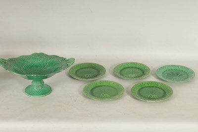 Lot 75 - FIVE 19TH CENTURY WEDGWOOD GREEN LEAF MOULDED PLATES, A SIMALR LARGE TWO HANDLED FOOTED TAZZA, A ST CLEMENT FRANCE PARROT JUG AND A POTTERY BAMBI FIGURE