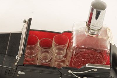 Lot 673 - A 20TH CENTURY BLACK PAINTED NOVELTY MUSICAL ROLLS ROYCE TABLE LIQUEUR DECANTER SET