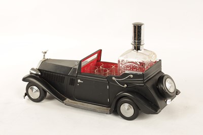 Lot 673 - A 20TH CENTURY BLACK PAINTED NOVELTY MUSICAL ROLLS ROYCE TABLE LIQUEUR DECANTER SET