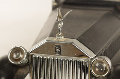 Lot 673 - A 20TH CENTURY BLACK PAINTED NOVELTY MUSICAL ROLLS ROYCE TABLE LIQUEUR DECANTER SET