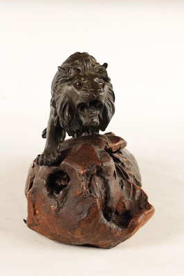 Lot 166 - A JAPANESE MEIJI PERIOD PATINATED BRONZE SCULPTURE OF A LION