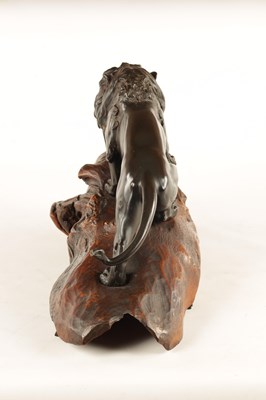 Lot 166 - A JAPANESE MEIJI PERIOD PATINATED BRONZE SCULPTURE OF A LION