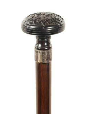 Lot 572 - A 19TH CENTURY CARVED EBONY AND CALAMANDA WALKING CANE