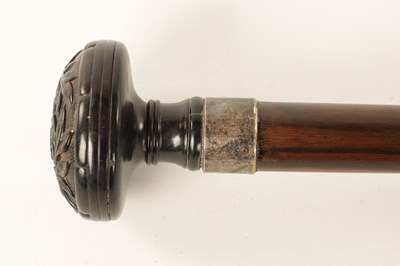 Lot 572 - A 19TH CENTURY CARVED EBONY AND CALAMANDA WALKING CANE