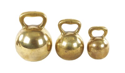 Lot 529 - A SET OF THREE 19TH-CENTURY GRADUATED BELL METAL WEIGHTS