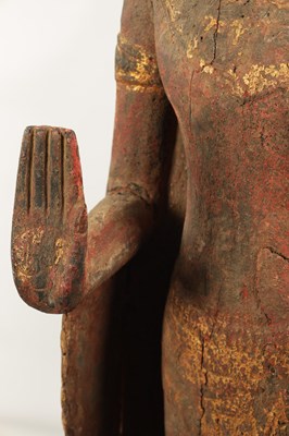 Lot 123 - AN EARLY TIBETAN LIFE-SIZE GILT AND RED LACQUER CARVED STANDING FIGURE OF A BUDDHA