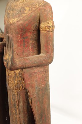 Lot 123 - AN EARLY TIBETAN LIFE-SIZE GILT AND RED LACQUER CARVED STANDING FIGURE OF A BUDDHA