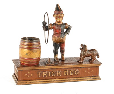 Lot 576 - AN EARLY 20TH CENTURY PAINTED CAST IRON 'TRICK DOG' MONEY BOX