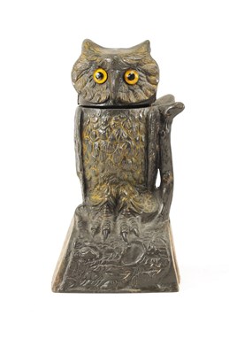 Lot 578 - AN EARLY 20TH CENTURY PAINTED CAST IRON MECHANICAL "OWL TURNS HEAD" MONEY BOX