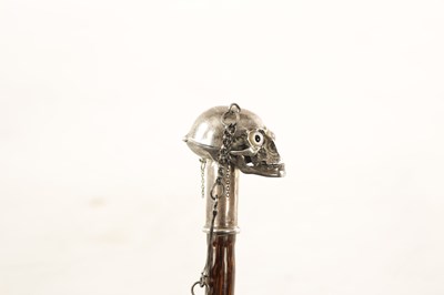 Lot 574 - AN UNUSUAL 19TH CENTURY SILVER TOPPED WALKING STICK WITH HINGED SKULL POMMEL