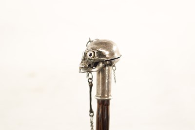 Lot 574 - AN UNUSUAL 19TH CENTURY SILVER TOPPED WALKING STICK WITH HINGED SKULL POMMEL