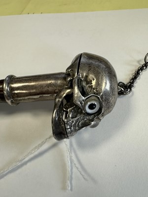 Lot 574 - AN UNUSUAL 19TH CENTURY SILVER TOPPED WALKING STICK WITH HINGED SKULL POMMEL