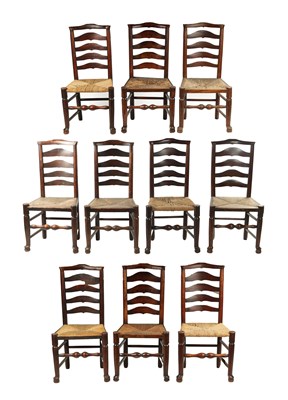 Lot 353 - A SET OF TEN EARLY 19TH CENTURY ELM RUSH SEAT LADDER BACK CHAIRS