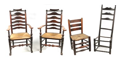 Lot 340 - A PAIR OF 19TH CENTURY ELM LADDER BACK RUSH SEAT ARMCHAIRS