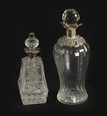 Lot 113 - A LATE VICTORIAN SILVER-MOUNTED GLASS LIQUEUR DECANTER AND STOPPER AND GEORGE V SILVER MOUNTED CUT GLASS DRESSING TABLE BOTTLE AND STOPPER