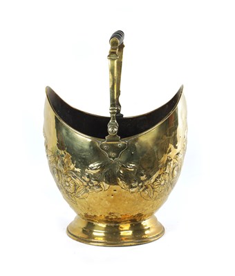 Lot 152 - A 19TH CENTURY FRENCH FLORALLY EMBOSSED DOUBLE-SIDED BRASS COAL BUCKET